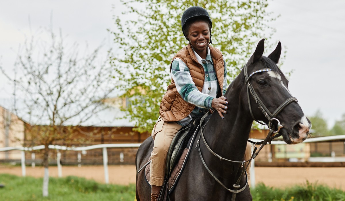 Woman Riding Horse at Country Farm